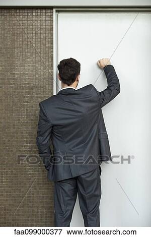 Businessman knocking on door, rear view View Large Photo Image Stock Photo - Businessman knocking on door, rear view. Fotosearch