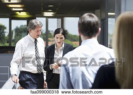 Businessman seeking advice from colleague View Large Photo Image Stock Photo - Businessman seeking advice from colleague. Fotosearch