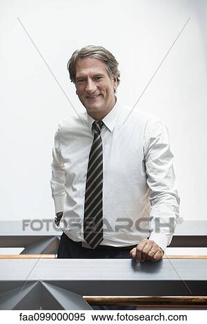 Businessman smiling cheerfully, portrait View Large Photo Image Stock Photography - Businessman smiling cheerfully, portrait. Fotosearch