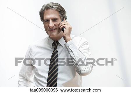 Stock Photograph - Businessman talking on cell phone. Fotosearch