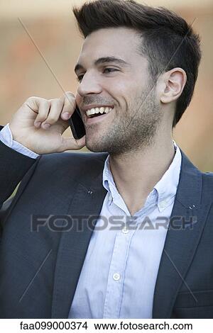 Businessman using cell phone outdoors View Large Photo Image Picture - Businessman using cell phone outdoors. Fotosearch
