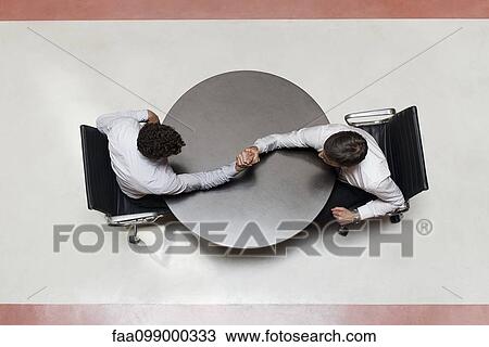 Stock Image - Businessmen arm wrestling. Fotosearch