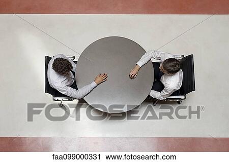 Businessmen stting opposite each other View Large Photo Image Stock Image - Businessmen stting opposite each other. Fotosearch