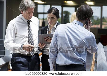 Businesswoman showing colleague digital tablet View Large Photo Image Stock Image - Businesswoman showing colleague digital tablet. Fotosearch