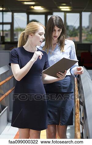 Businesswomen reviewing business document View Large Photo Image Stock Image - Businesswomen reviewing business document. Fotosearch