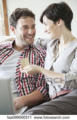 Couple using credit card to shop online View Large Photo Image Stock Image - Couple using credit card to shop online. Fotosearch