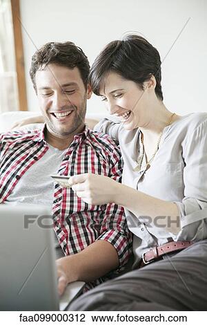 Couple using credit card to shop online View Large Photo Image Stock Image - Couple using credit card to shop online. Fotosearch