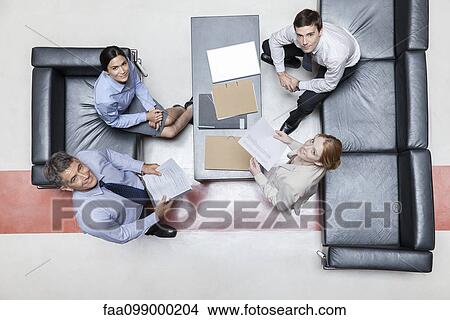 Executives in meeting, overhead view View Large Photo Image Picture - Executives in meeting, overhead view. Fotosearch