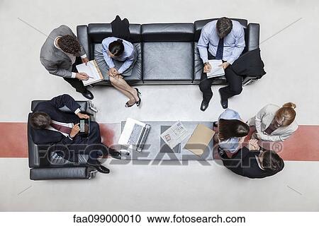 Executives in meeting, overhead view View Large Photo Image Stock Image - Executives in meeting, overhead view. Fotosearch