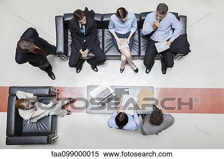Stock Photography - Executives in meeting, overhead view. Fotosearch
