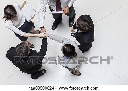 Executives shaking hands, overhead view View Large Photo Image Stock Photo - Executives shaking hands, overhead view. Fotosearch