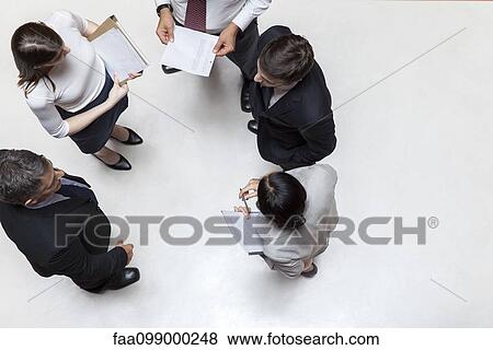 Executives standing in meeting, overhead view View Large Photo Image Stock Photo - Executives standing in meeting, overhead view. Fotosearch