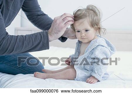 Father fixing baby girl's hair, cropped View Large Photo Image Stock Photograph - Father fixing baby girl's hair, cropped. Fotosearch