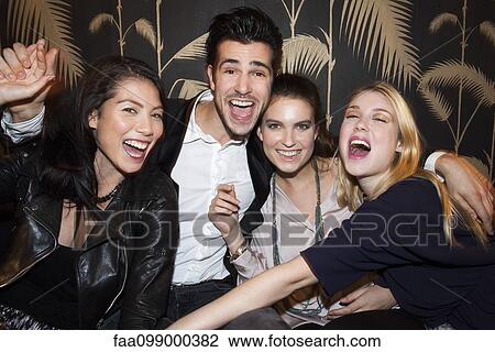 Friends celebrating at night club View Large Photo Image Stock Image - Friends celebrating at night club. Fotosearch
