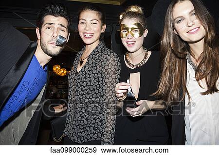 Friends celebrating at party View Large Photo Image Stock Photo - Friends celebrating at party. Fotosearch