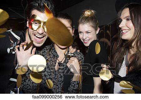 Stock Photograph - Friends celebrating at party. Fotosearch