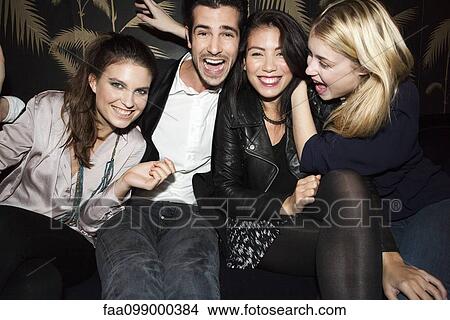 Friends celebrating holiday at night club View Large Photo Image Picture - Friends celebrating holiday at night club. Fotosearch