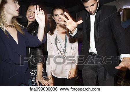 Friends cutting loose on the dance floor View Large Photo Image Stock Photograph - Friends cutting loose on the dance floor. Fotosearch