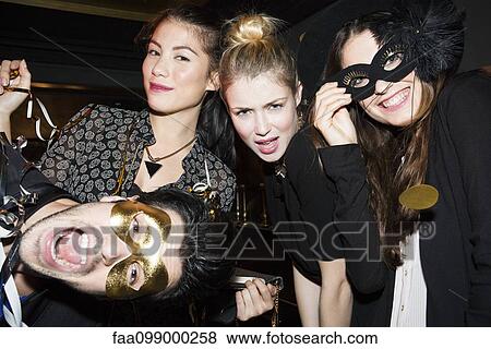 Stock Photo - Friends having fun celebrating at party. Fotosearch
