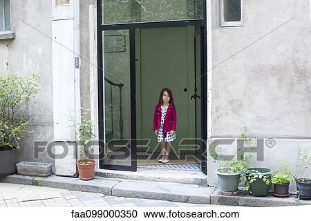 Girl in doorway of home, looking out View Large Photo Image Stock Image - Girl in doorway of home, looking out. Fotosearch