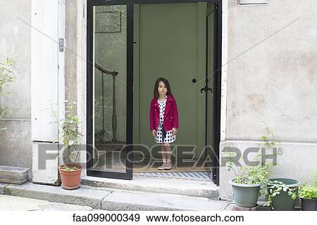 Girl in doorway of home, looking out View Large Photo Image Stock Photo - Girl in doorway of home, looking out. Fotosearch