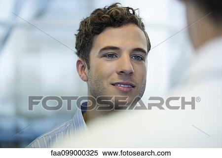 Stock Photography - Intern chatting with member of staff. Fotosearch