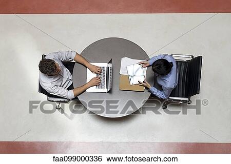 Interns working in shared office space View Large Photo Image Stock Photograph - Interns working in shared office space. Fotosearch