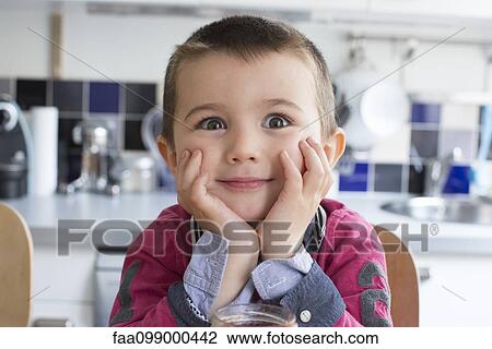 Little boy with chin resting on hands, looking surprised View Large Photo Image Stock Image - Little boy with chin resting on hands, looking surprised. Fotosearch