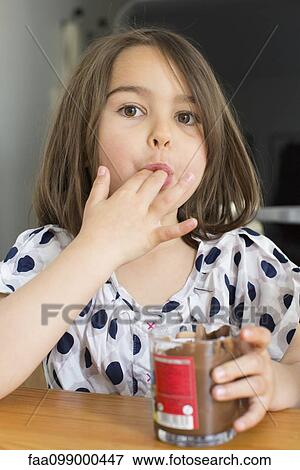 Little girl eating chocolate sauce from a jar with her fingers View Large Photo Image Stock Photo - Little girl eating chocolate sauce from a jar with her fingers. Fotosearch