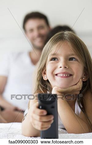 Little girl holding remote control View Large Photo Image Stock Image - Little girl holding remote control. Fotosearch