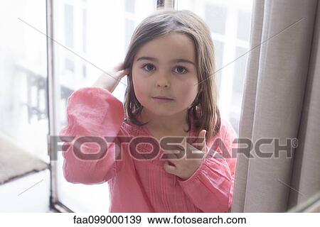 Little girl in front of window, portrait View Large Photo Image Stock Photo - Little girl in front of window, portrait. Fotosearch