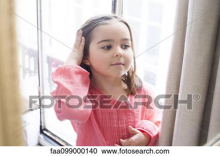 Little girl in front of window View Large Photo Image Stock Image - Little girl in front of window. Fotosearch