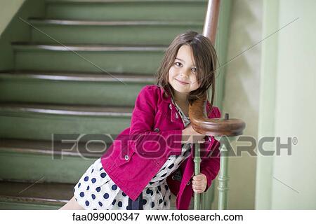 Little girl leaning against bannister, portrait View Large Photo Image Stock Photo - Little girl leaning against bannister, portrait. Fotosearch