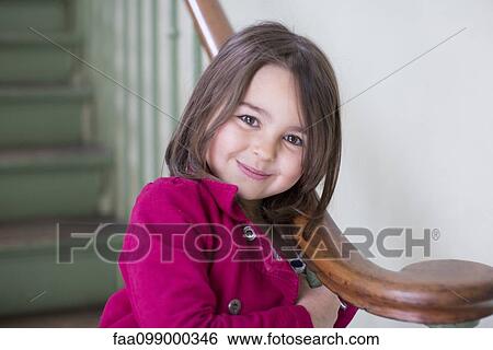 Little girl leaning against bannister, portrait View Large Photo Image Stock Photograph - Little girl leaning against bannister, portrait. Fotosearch