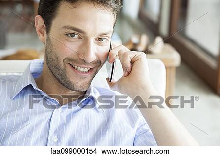 Man talking on cell phone, portrait View Large Photo Image Picture - Man talking on cell phone, portrait. Fotosearch