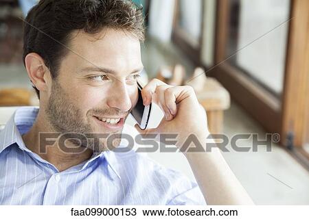 Stock Image - Man talking on cell phone. Fotosearch