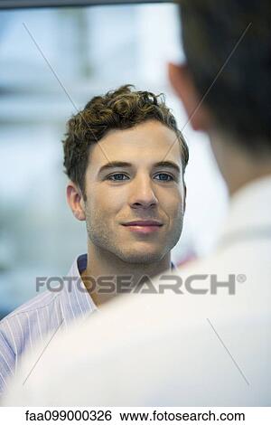 Office worker chatting with colleague View Large Photo Image Stock Photograph - Office worker chatting with colleague. Fotosearch