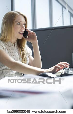 Office worker distracted from work by personal phone call View Large Photo Image Stock Photo - Office worker distracted from work by personal phone call. Fotosearch