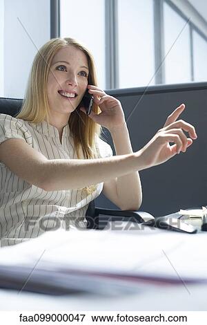 Office worker taking important phone call on smartphone View Large Photo Image Stock Photo - Office worker taking important phone call on smartphone. Fotosearch
