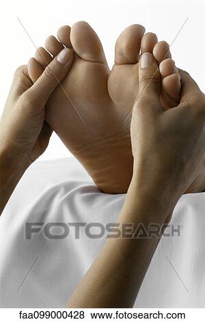 Stock Photo - Person receiving foot massage, close-up. Fotosearch