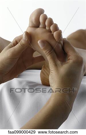 Stock Photo - Person receiving foot massage, close-up. Fotosearch
