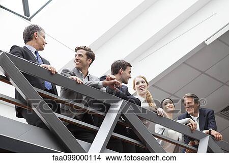 Team of executives talking together on balcony View Large Photo Image Picture - Team of executives talking together on balcony. Fotosearch