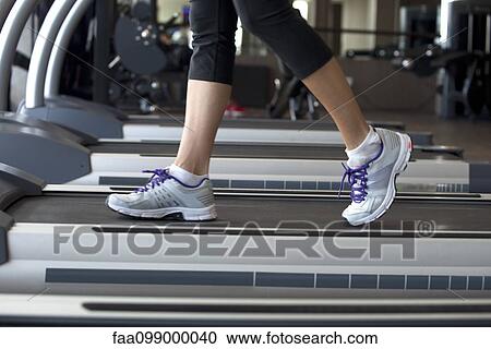 Stock Image - Walking on treadmill. Fotosearch