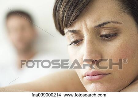 Picture - Woman contemplative and withdrawn after disagreement with husband. Fotosearch