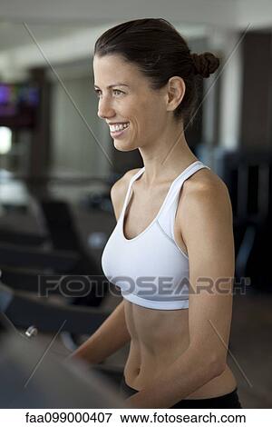 Woman exercising on treadmill in health club View Large Photo Image Stock Photo - Woman exercising on treadmill in health club. Fotosearch