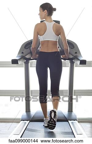 Picture - Woman exercising on treadmill. Fotosearch