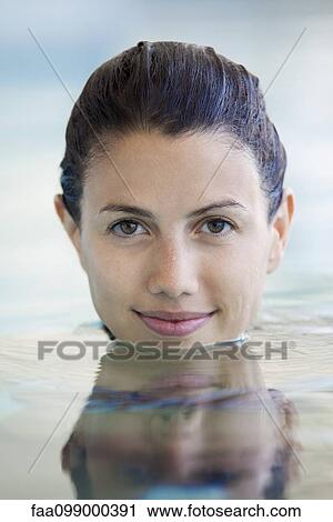 Woman relaxing in swimming pool, portrait View Large Photo Image Stock Image - Woman relaxing in swimming pool, portrait. Fotosearch