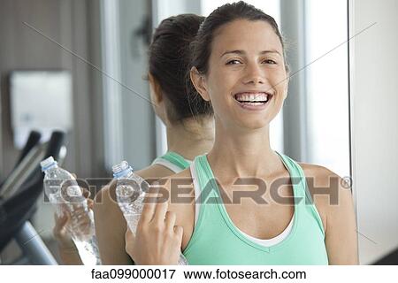 Woman relaxing with bottle of water View Large Photo Image Stock Photo - Woman relaxing with bottle of water. Fotosearch