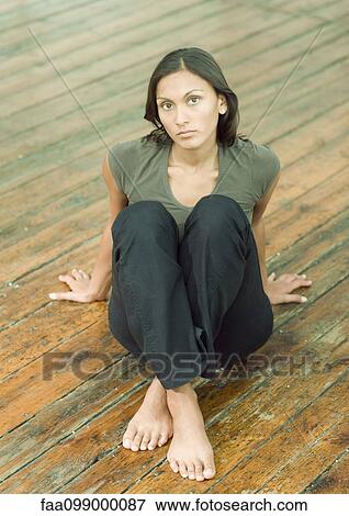 Woman sitting on floor, portrait View Large Photo Image Stock Photo - Woman sitting on floor, portrait. Fotosearch