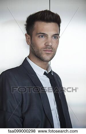 Young businessman waiting for elevator View Large Photo Image Stock Photo - Young businessman waiting for elevator. Fotosearch